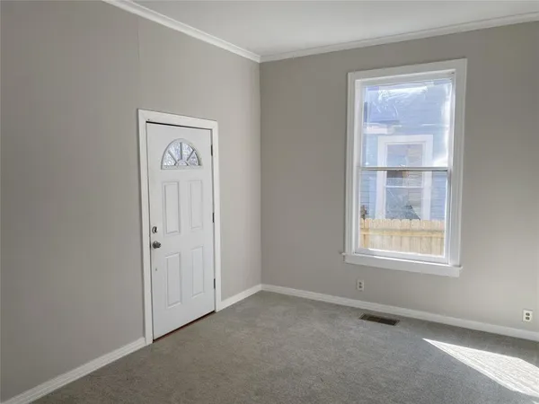 an empty room with windows and closet