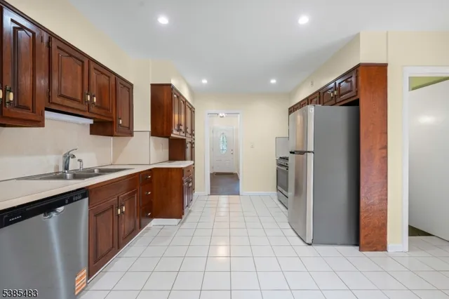 a kitchen with a stove a refrigerator and cabinets