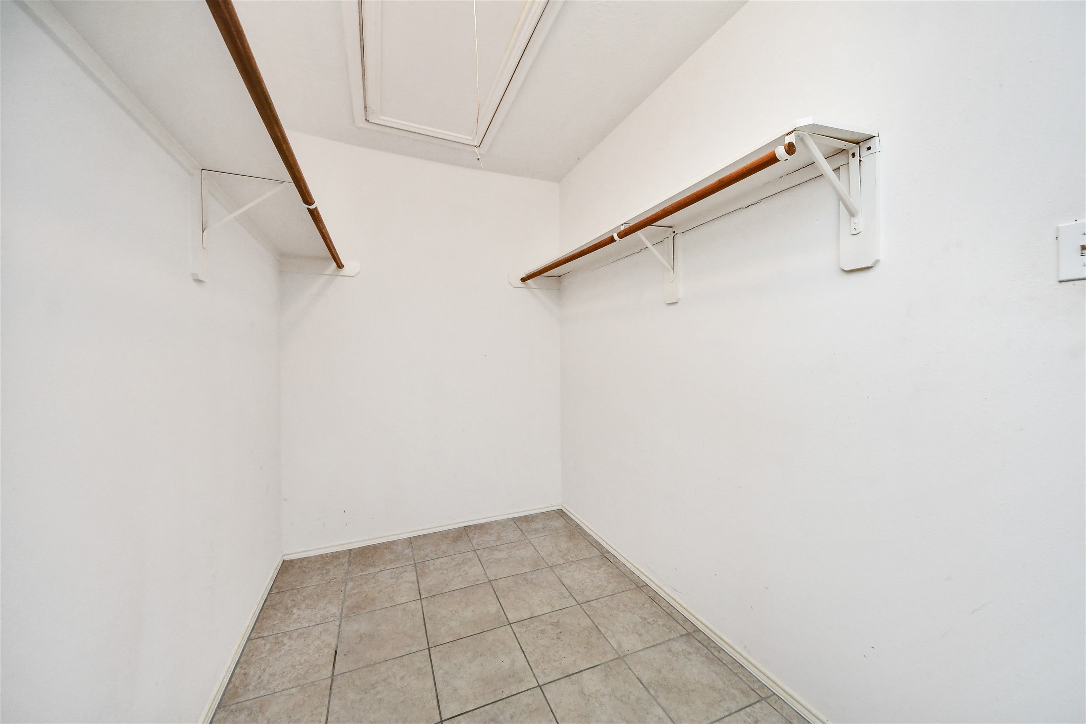 24019 Kingbriar Drive Spring, TX 77373 - Photo 30 of 41 Located within the primary suite, this spacious full entry closet provides ample hanging rods and shelf space for organized storage.