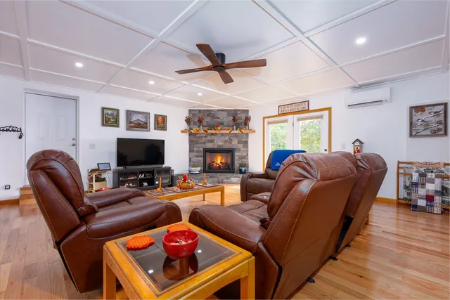 a dining room with furniture entryway and wooden floor
