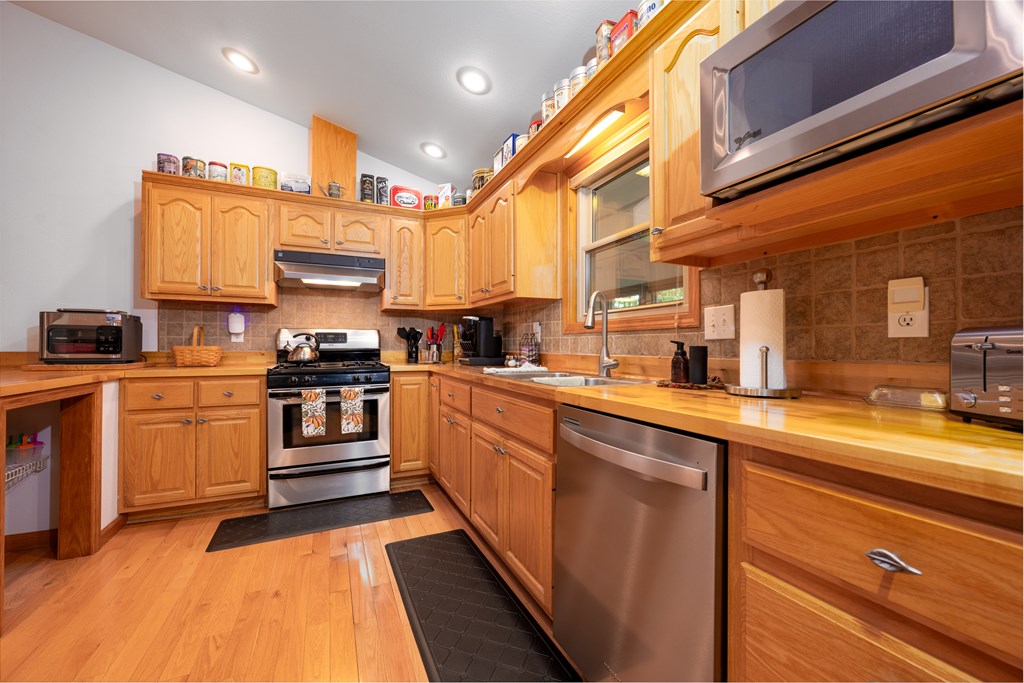124 Cornerstone Murphy, NC 28906 - Photo 21 of 57 a kitchen with stainless steel appliances and white cabinets
