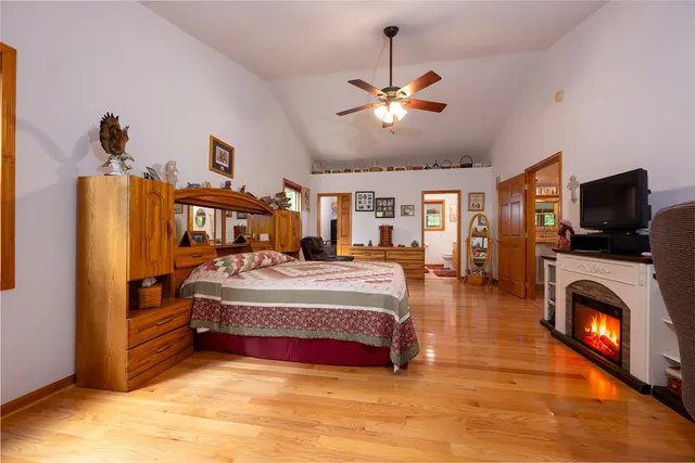 a bedroom with a bed and wooden floor