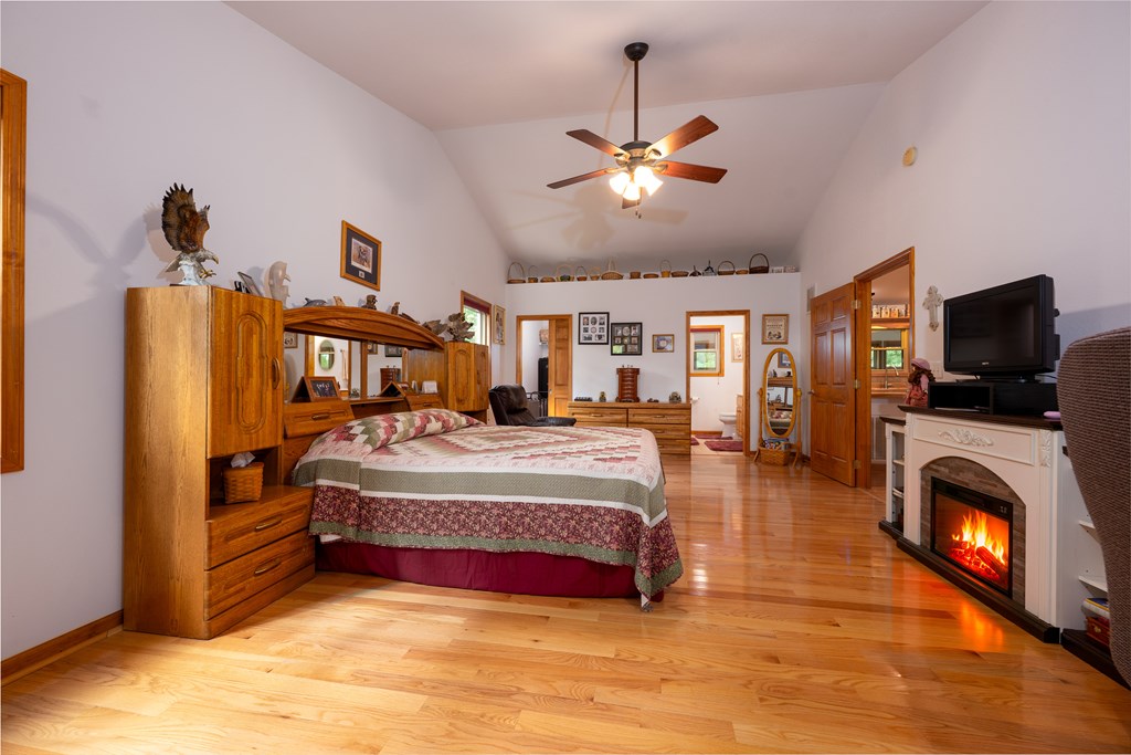 124 Cornerstone Murphy, NC 28906 - Photo 25 of 57 a spacious bedroom with a bed and a flat screen tv