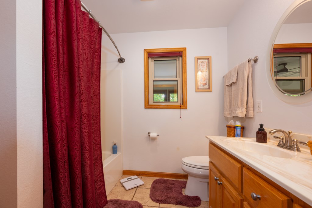 124 Cornerstone Murphy, NC 28906 - Photo 27 of 57 a bathroom with a granite countertop toilet sink and mirror