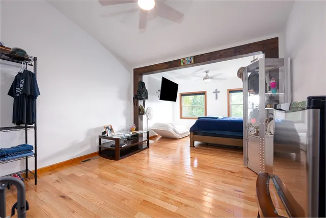 a bathroom with a granite countertop sink a toilet and shower