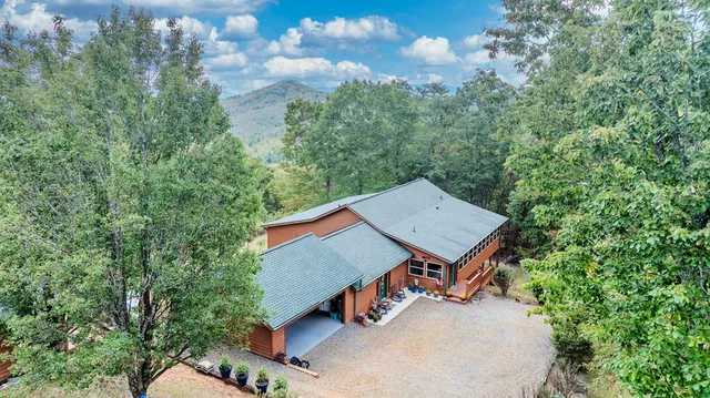 a aerial view of a house with swimming pool next to a yard