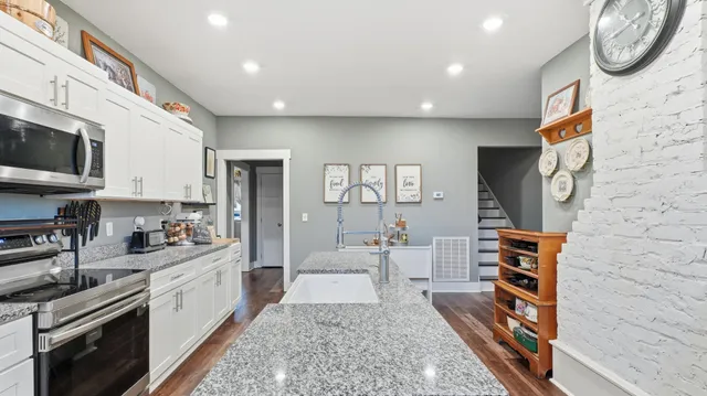 a kitchen with stainless steel appliances granite countertop a stove and a refrigerator