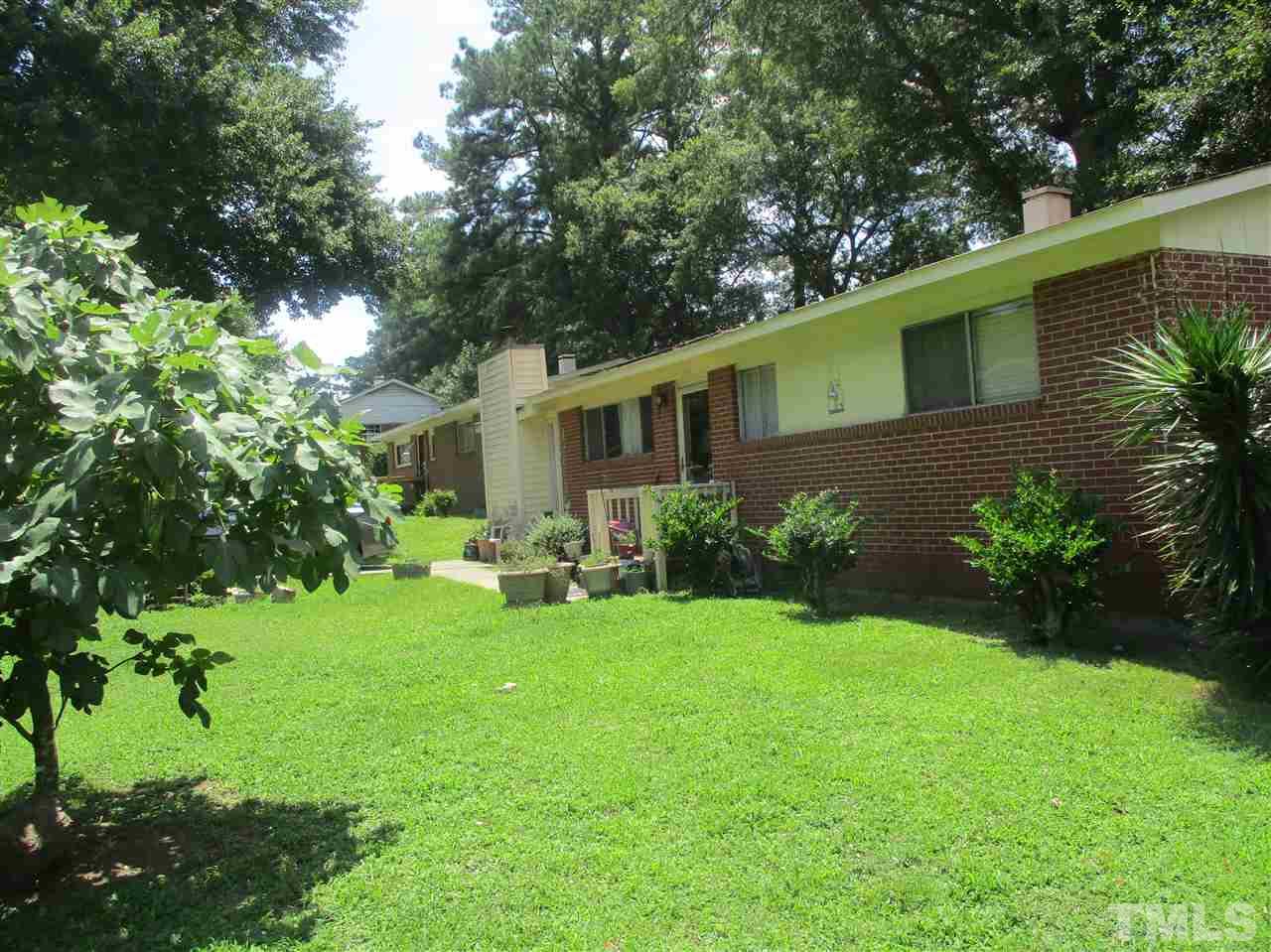 1908 Boaz Road Raleigh, NC 27610 - Photo 1 of 6 a view of a house with backyard sitting area and garden