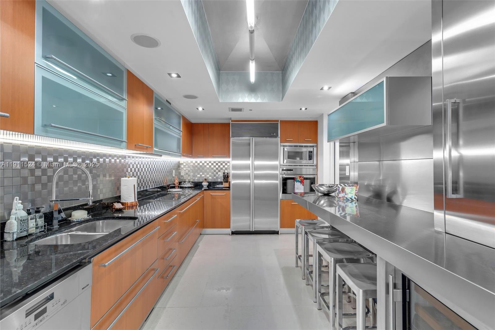 400 Alton Road, Unit 706 Miami Beach, FL 33139 - Photo 12 of 38 a kitchen with stainless steel appliances granite countertop lots of counter top space a sink and cabinets