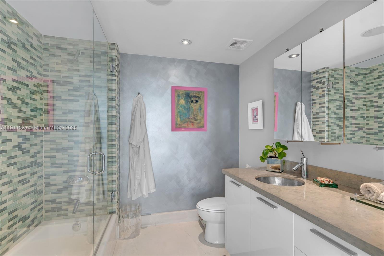 400 Alton Road, Unit 706 Miami Beach, FL 33139 - Photo 24 of 38 a bathroom with a granite countertop sink toilet and shower