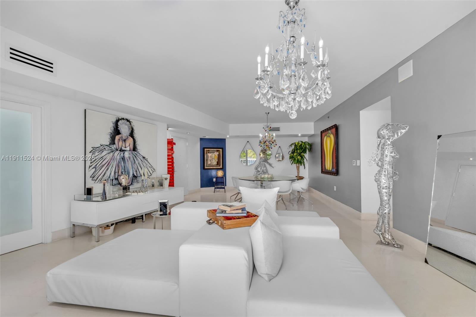 400 Alton Road, Unit 706 Miami Beach, FL 33139 - Photo 8 of 38 a living room with furniture and a chandelier