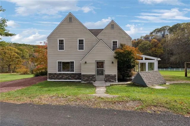 a front view of house with yard and green space