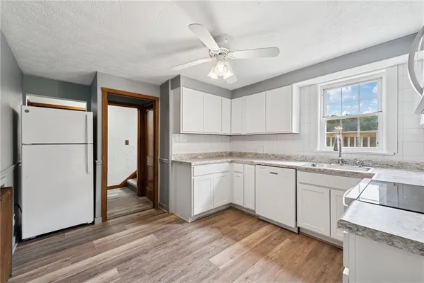 a kitchen with stainless steel appliances granite countertop a refrigerator and a sink