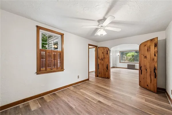 wooden floor in an empty room with a window