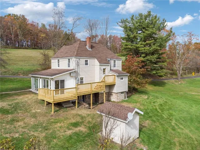 a aerial view of a house with a yard table and chairs