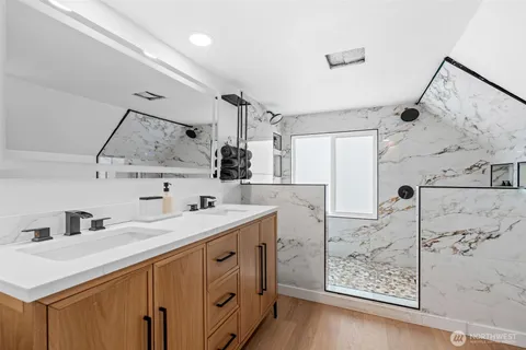 a kitchen with a sink cabinets and wooden floor