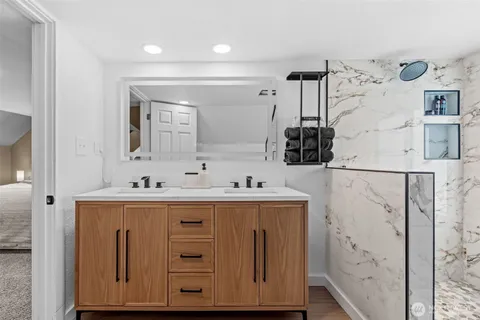 a bathroom with a sink a mirror and a shower