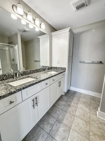 a spacious bathroom with a granite countertop sink mirror and a