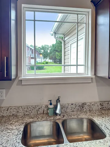 a kitchen sink sitting next to a window
