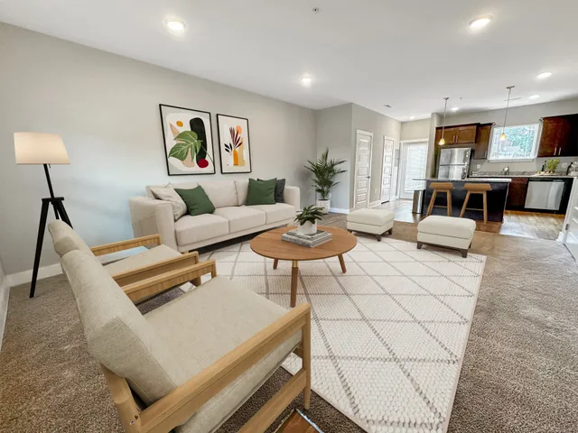 a living room with furniture and wooden floor