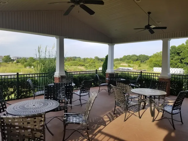 a view of a patio with chairs and table in patio