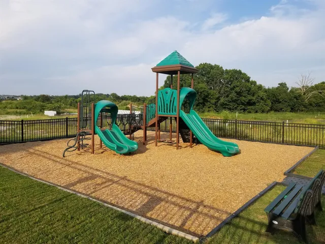 a view of a swimming pool with a patio and a garden
