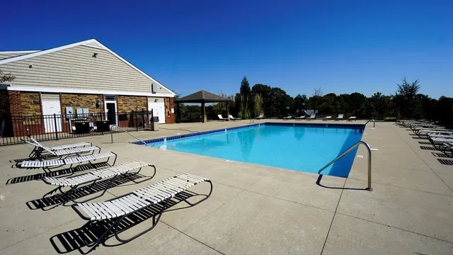 a swimming pool with outdoor seating and yard