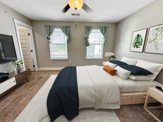 a bedroom with a bed and a flat screen tv