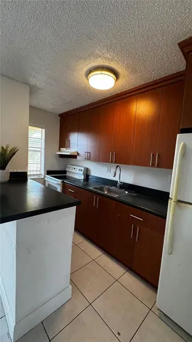 a kitchen with stainless steel appliances granite countertop a sink and a stove