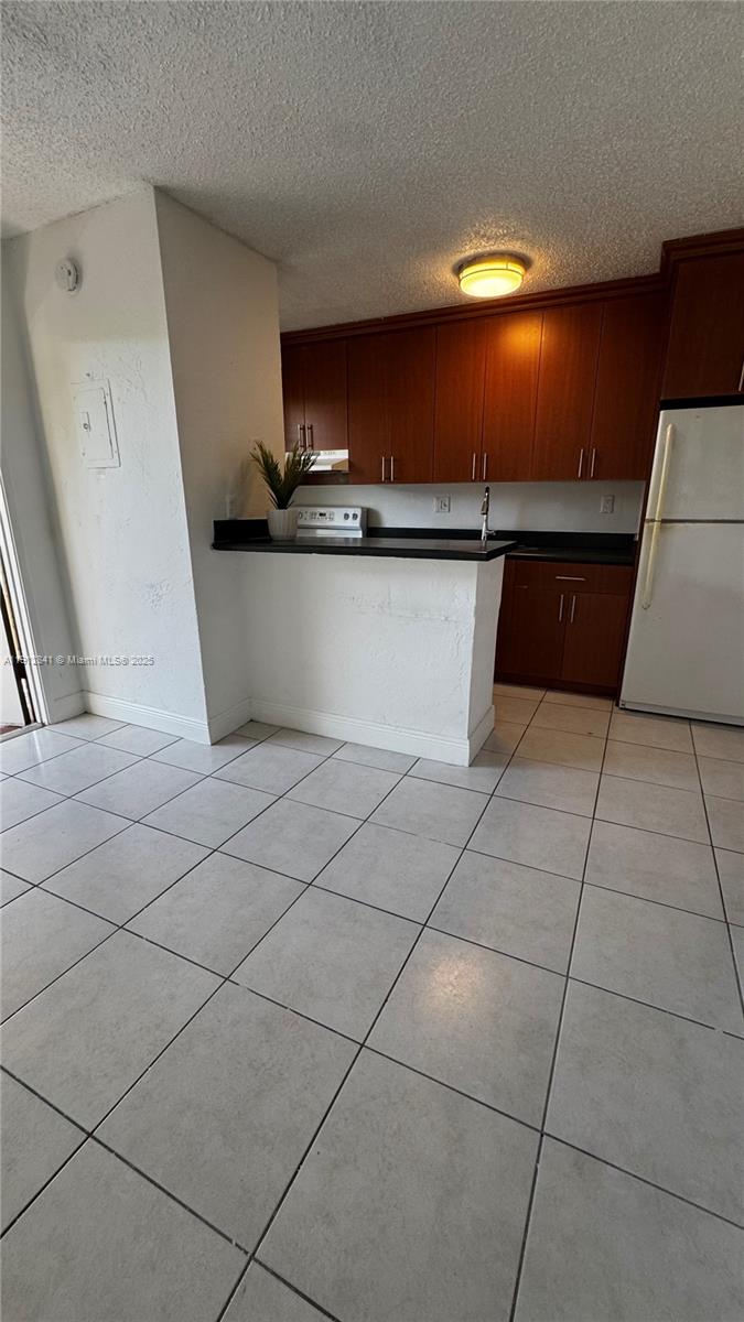 4081 North Dixie Highway, Unit 20 Oakland Park, FL 33334 - Photo 5 of 7 a kitchen with granite countertop a rug and a stove