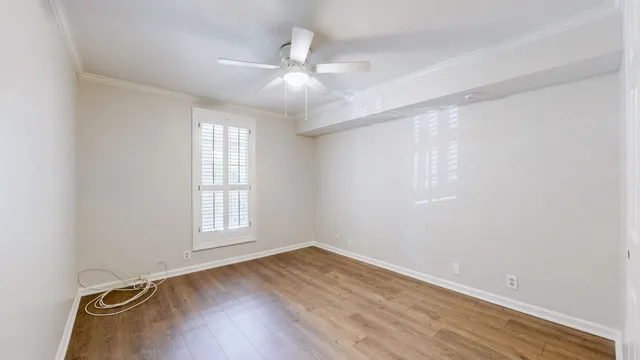 wooden floor in an empty room with a window