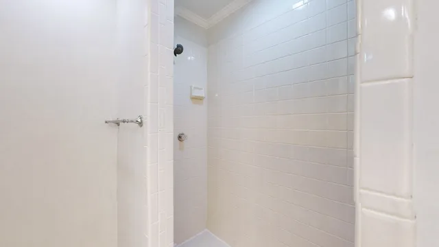 a bathroom with a tub sink vanity and mirror