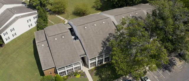 an aerial view of a house with a yard and lake view