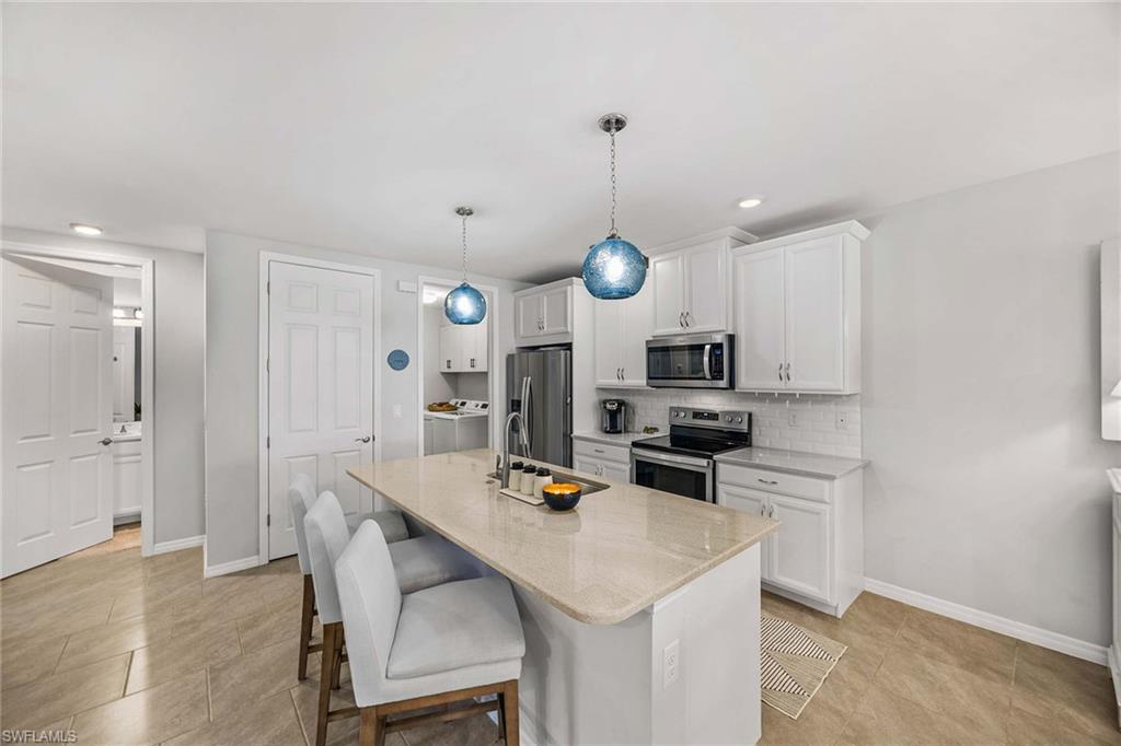 14610 Edgewater Circle Naples, FL 34114 - Photo 12 of 38 a kitchen with a table and chairs in it