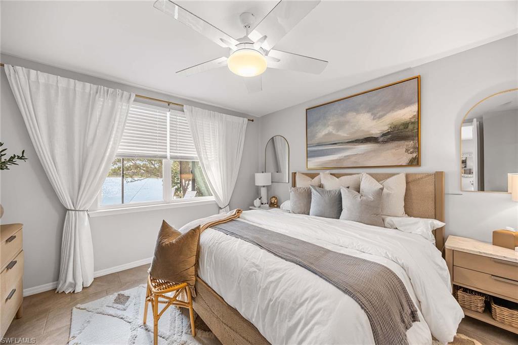 14610 Edgewater Circle Naples, FL 34114 - Photo 17 of 38 a bedroom with a bed and a painting on the wall