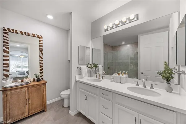 a bathroom with a shower a mirror and a sink