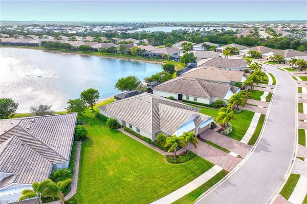 an aerial view of a house with a garden and lake view