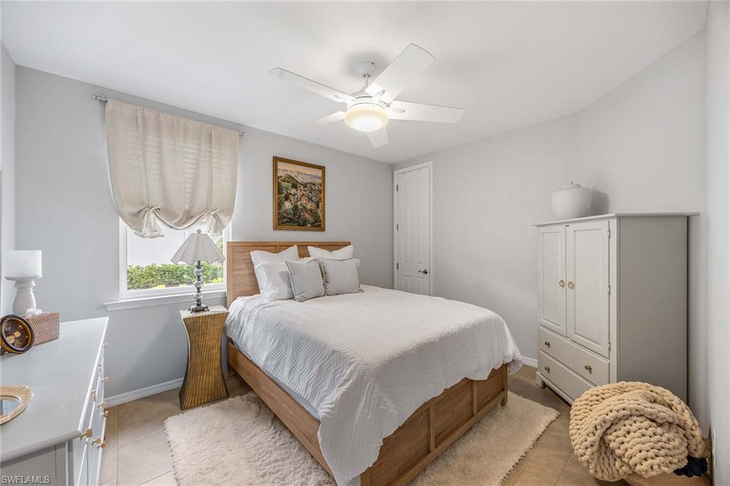 14610 Edgewater Circle Naples, FL 34114 - Photo 22 of 38 a bedroom with a bed and a window