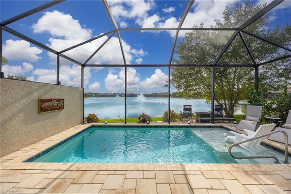 a swimming pool with outdoor seating and yard