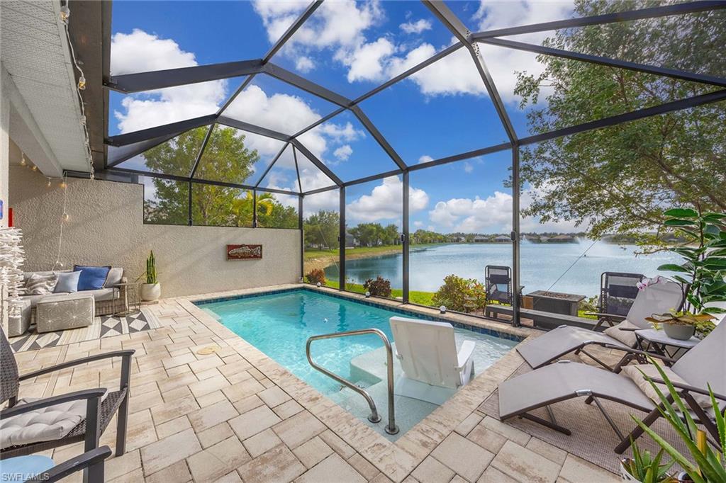 14610 Edgewater Circle Naples, FL 34114 - Photo 26 of 38 a swimming pool with outdoor seating and yard