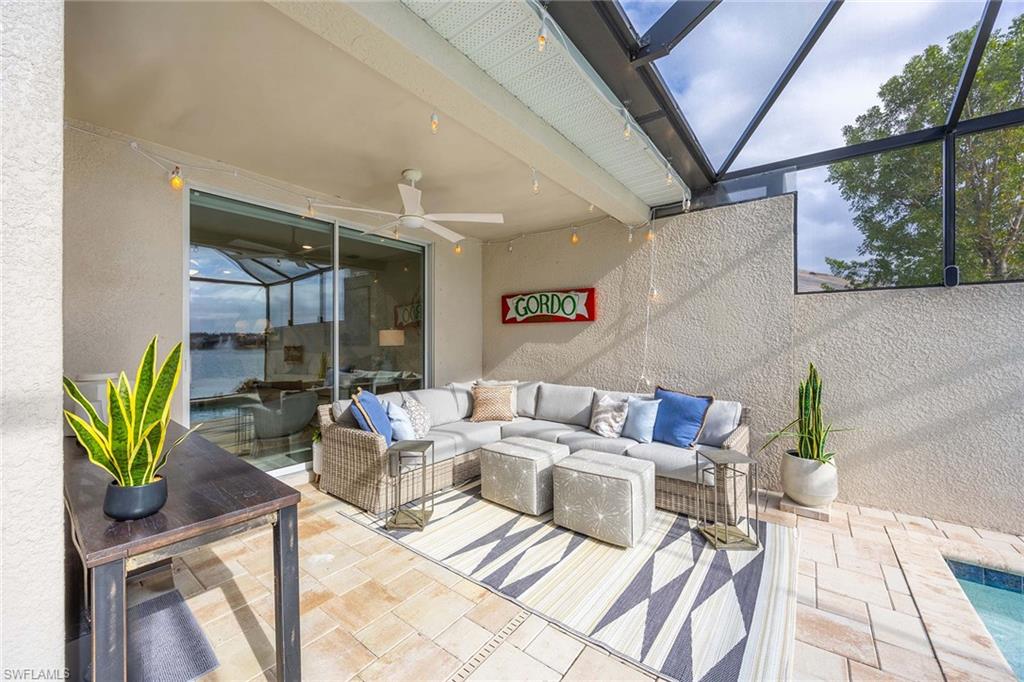 14610 Edgewater Circle Naples, FL 34114 - Photo 27 of 38 a view of a patio with table and chairs and potted plants