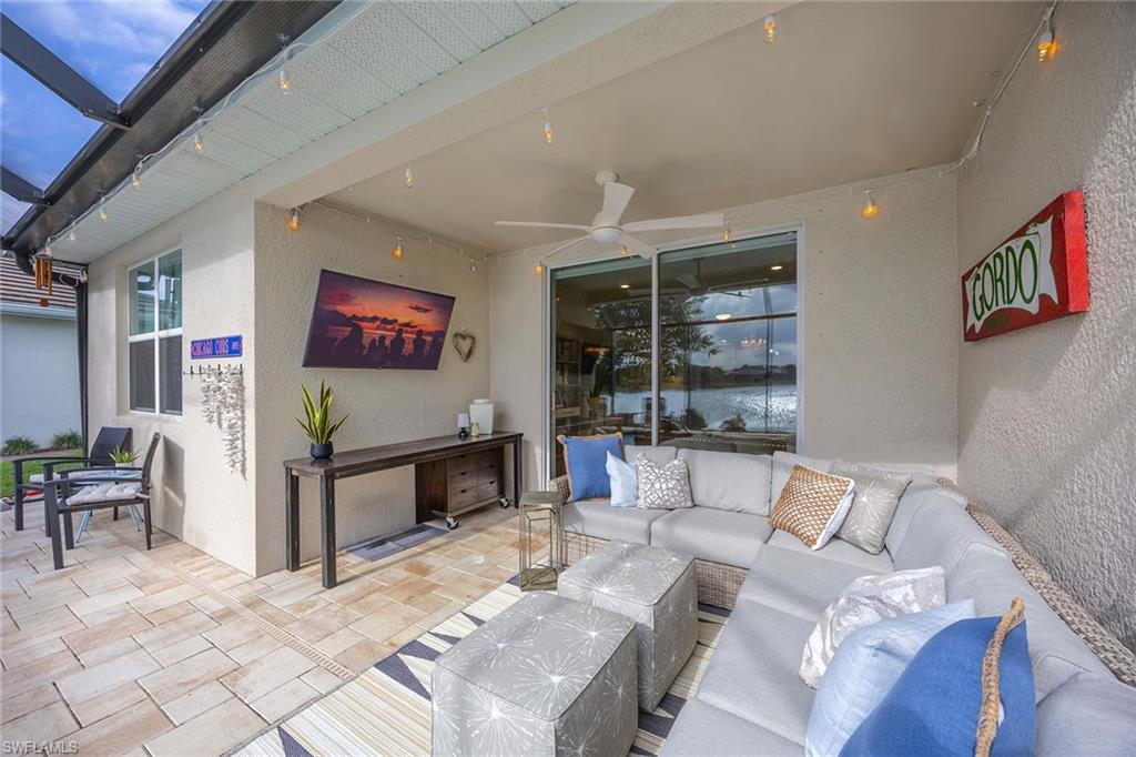 14610 Edgewater Circle Naples, FL 34114 - Photo 28 of 38 a living room with furniture and a flat screen tv