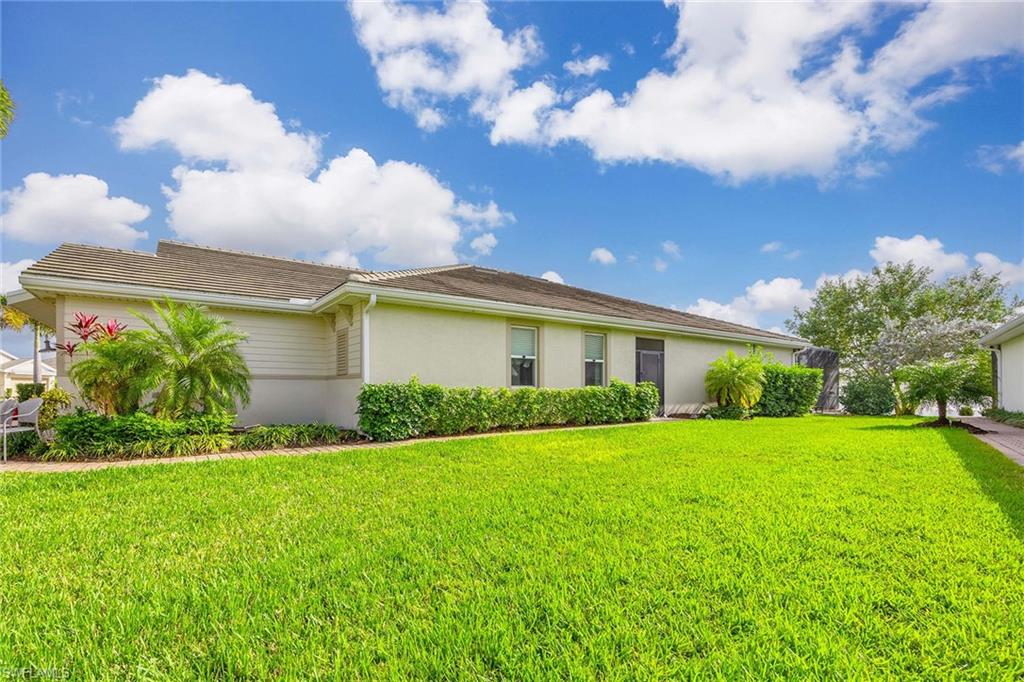 14610 Edgewater Circle Naples, FL 34114 - Photo 3 of 38 a front view of house with yard and green space