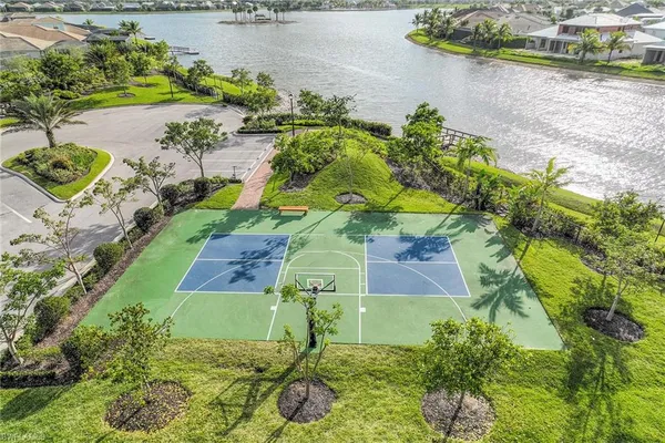 a view of a house with a yard and palm trees
