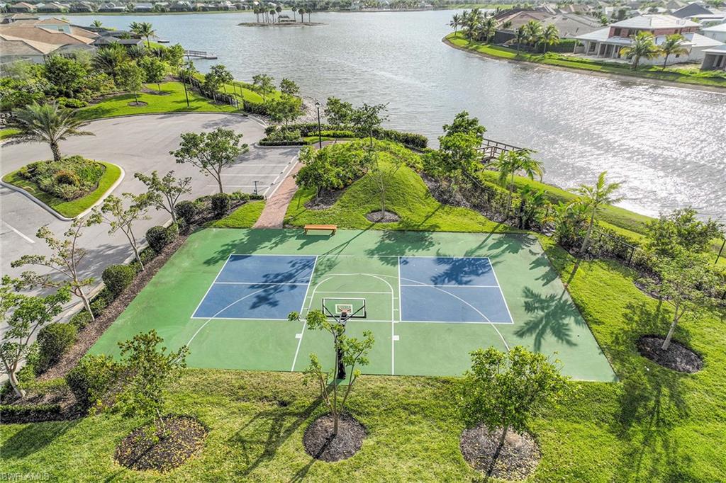 14610 Edgewater Circle Naples, FL 34114 - Photo 36 of 38 a view of a lake with a yard