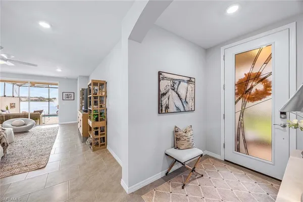 a living room with furniture a flat screen tv and a window