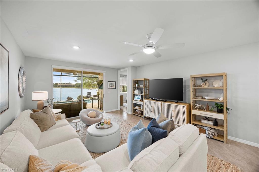 14610 Edgewater Circle Naples, FL 34114 - Photo 9 of 38 a living room with furniture and a flat screen tv