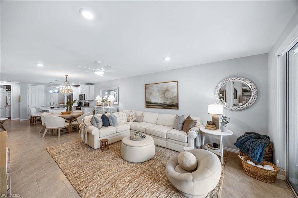 14610 Edgewater Circle Naples, FL 34114 - Photo 10 of 38 a living room with lots of white furniture and couches