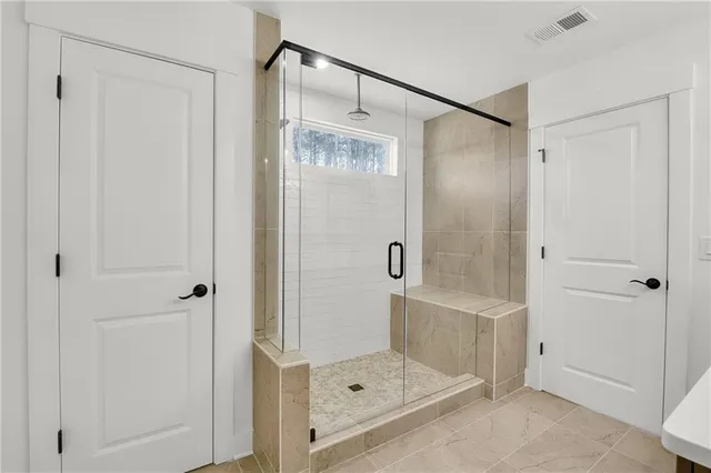 a bathroom with a glass shower door