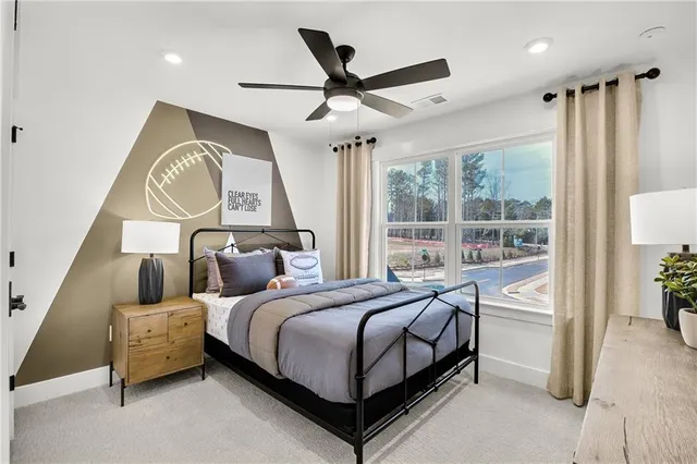 a bedroom with a bed and a large window